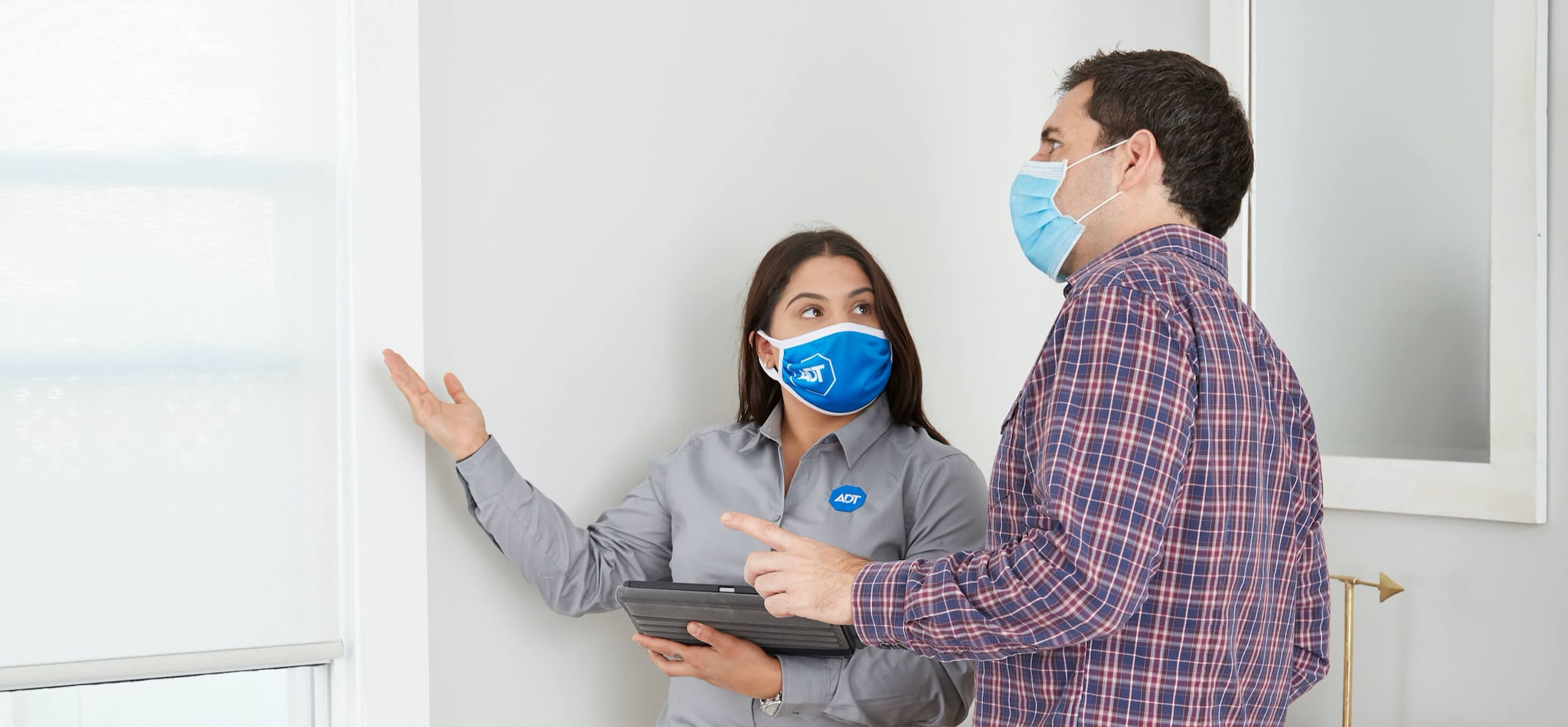 ADT sales agent with customer wearing face masks