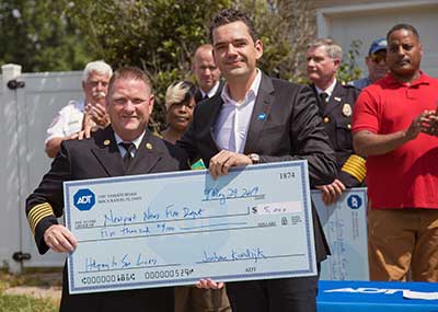 Presenting a $5,000 check to the Newport News and Chesapeake Fire Departments.